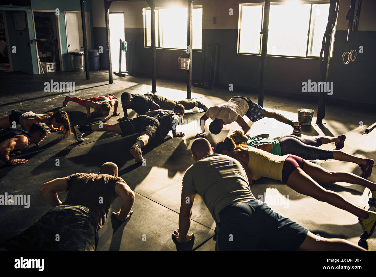 Fitness group doing push ups in gym Stock Photo