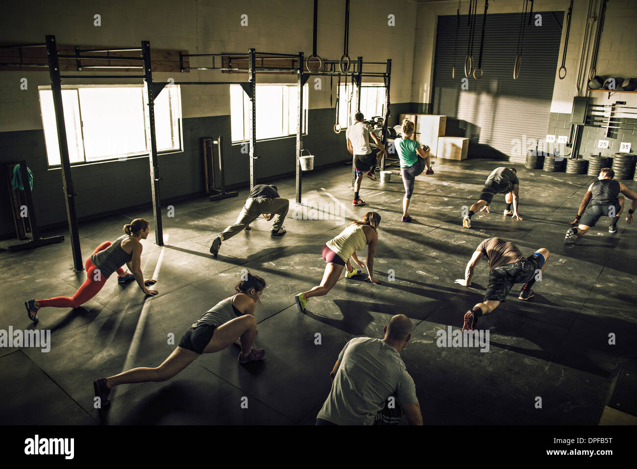 Fitness class training and stretching together in gym Stock Photo