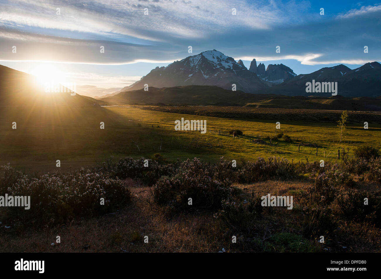 Late sunrays breaking through the clouds before the towers of the Torres del Paine National Park, Patagonia, Chile Stock Photo