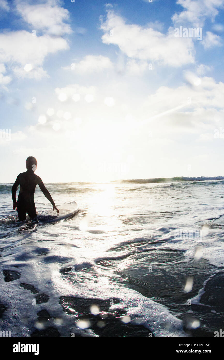 Boy in sea with surfboard, Encinitas, California, USA Stock Photo