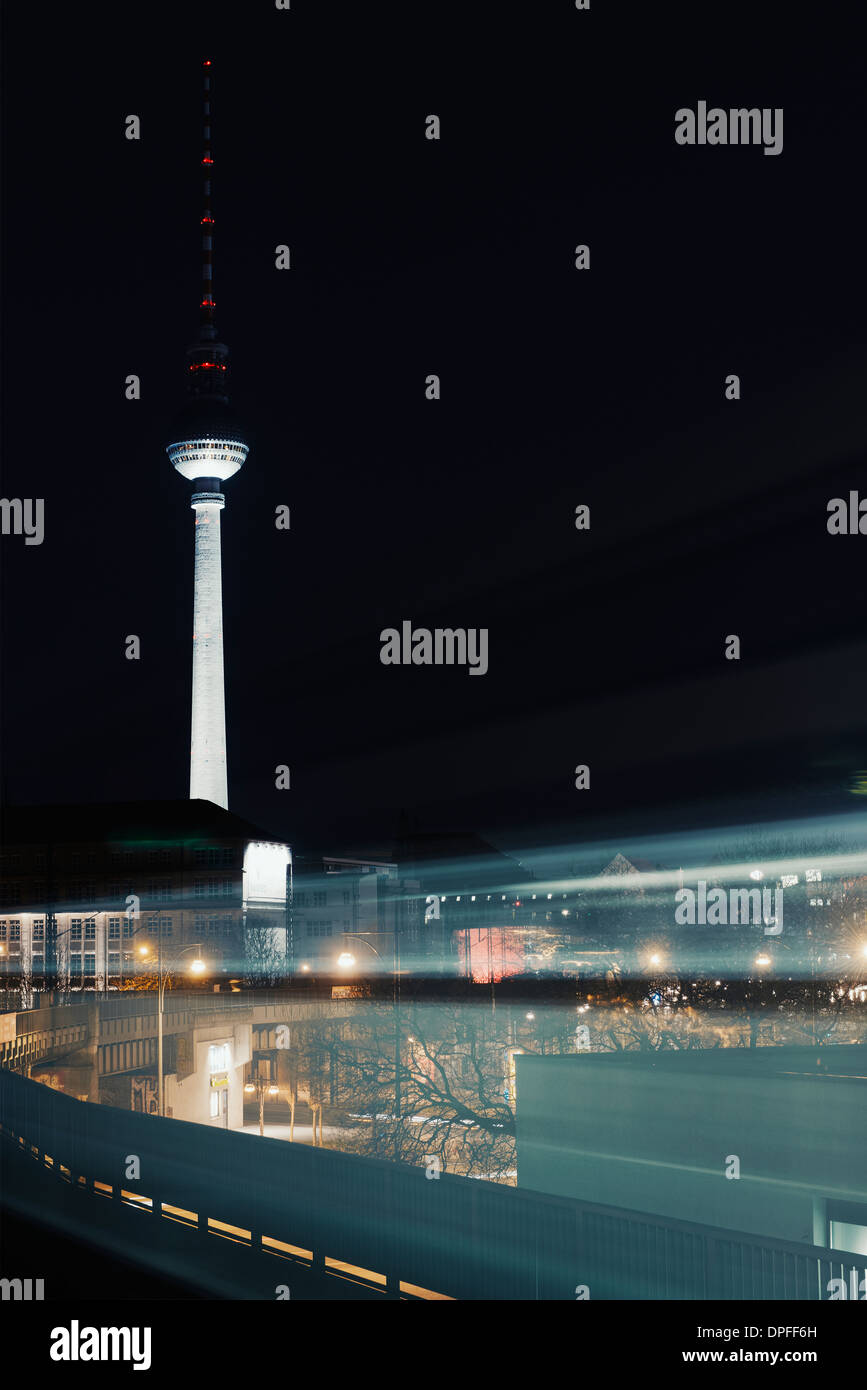 Moving train and television tower at night, Berlin, Germany Stock Photo