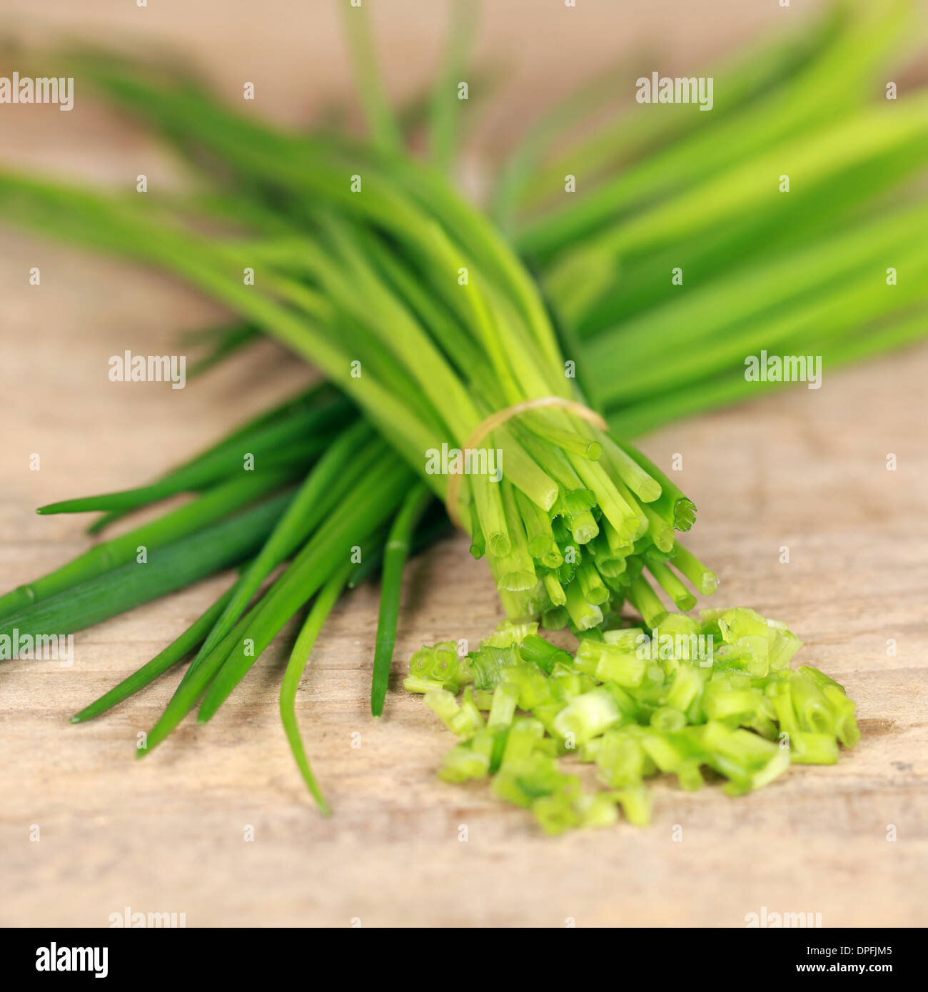 Chopped chives on a kitchen board, shallow depth of field Stock Photo
