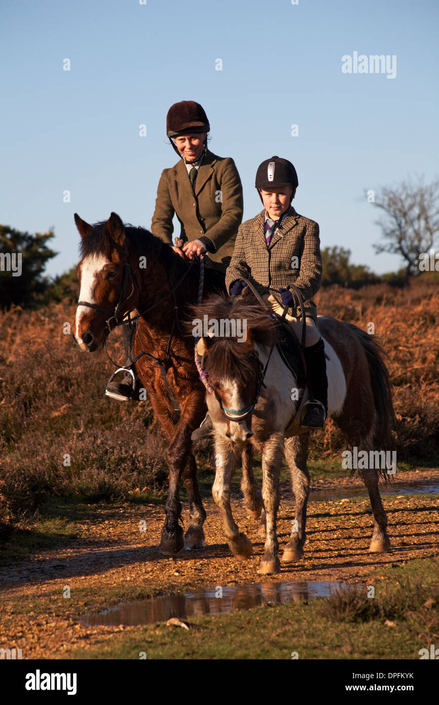 Horse riders horse riding at Bratley View, New Forest National Park, Hampshire UK in January