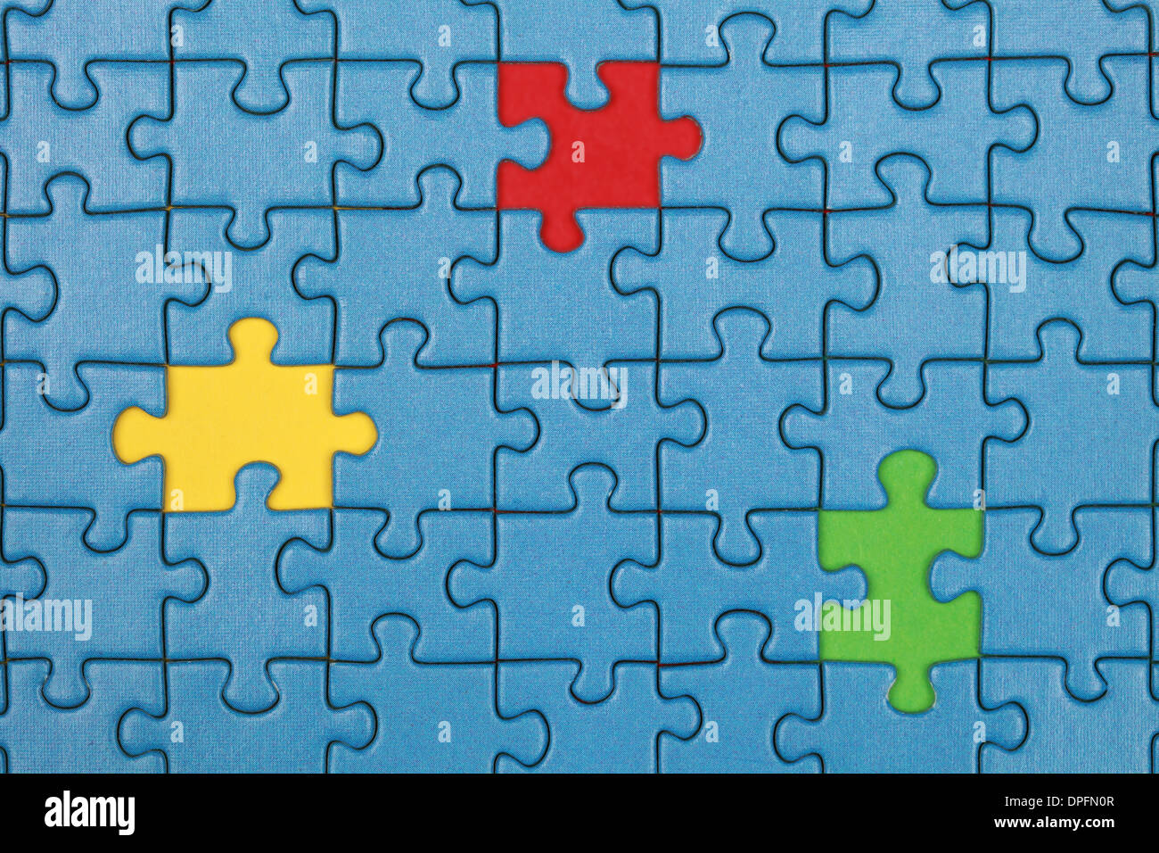 Jigsaw Puzzle with missing pieces in three different colors Stock Photo
