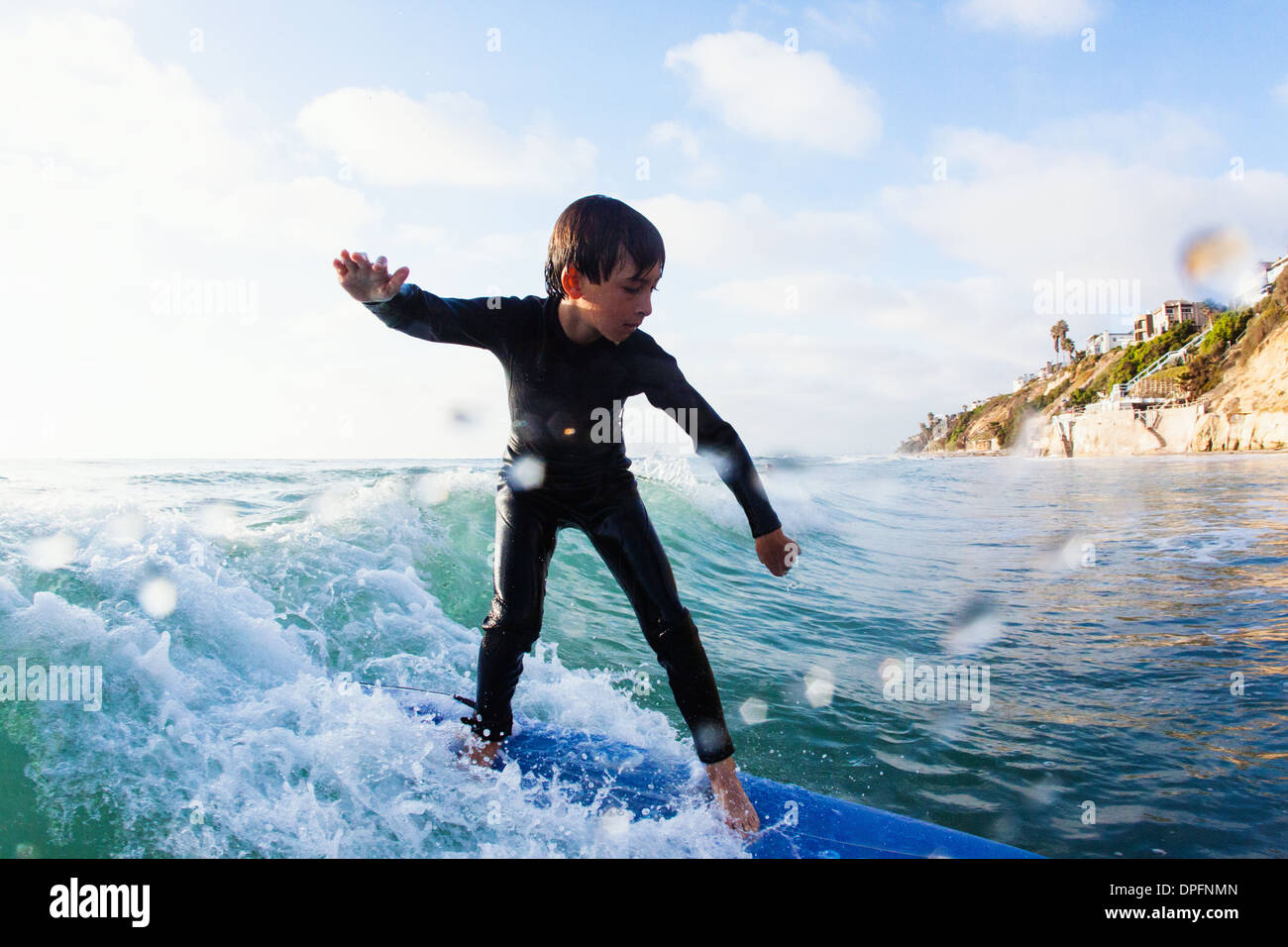 Young boy surfing wave, Encinitas, California, USA Stock Photo