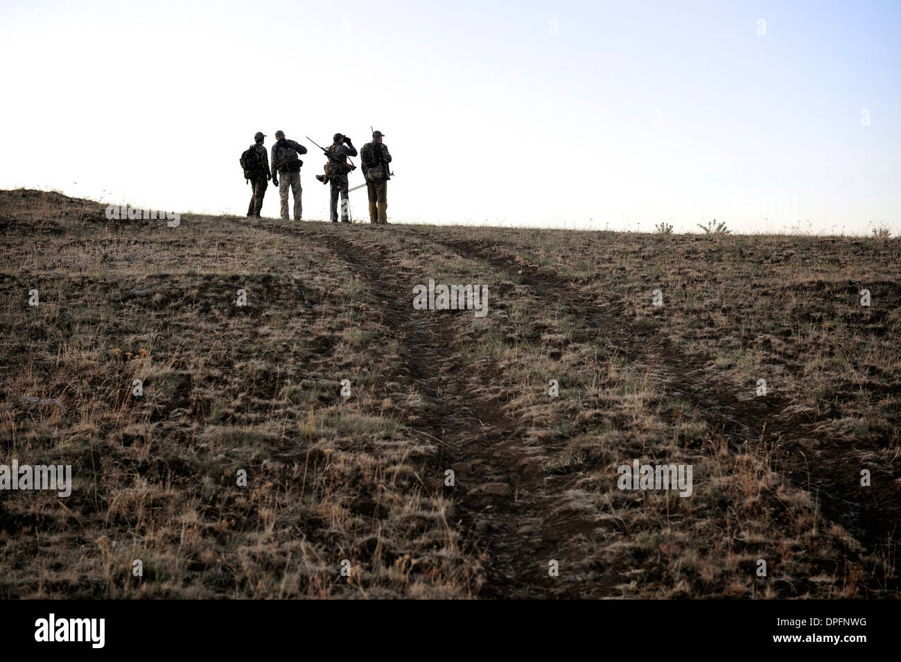 Four deer hunters on top of hill, John Day, Oregon, USA Stock Photo