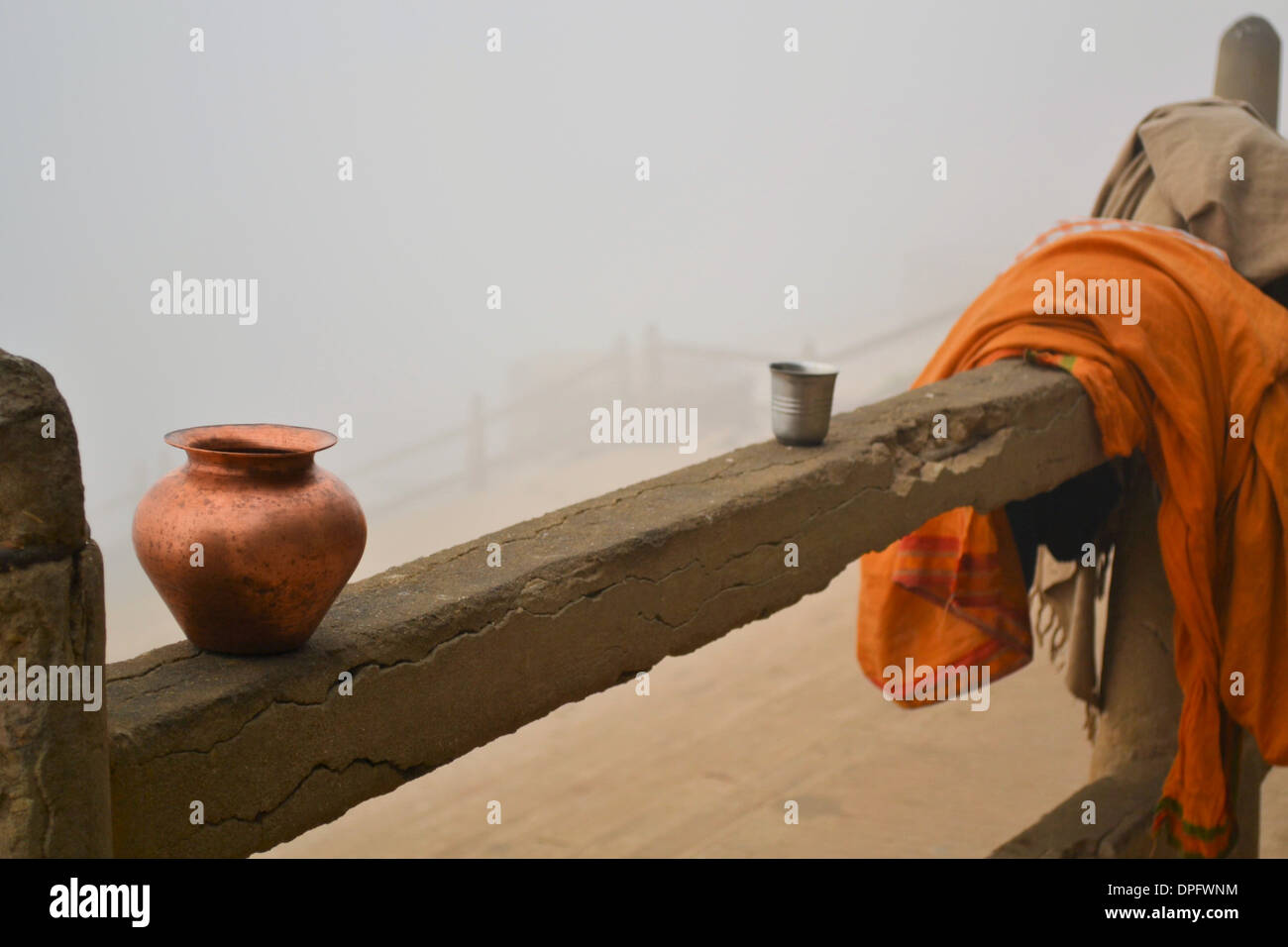 A Hindu Pilgrim is taking a morning bath in the holy river Ganges in Varanasi/Benares on a misty day Stock Photo
