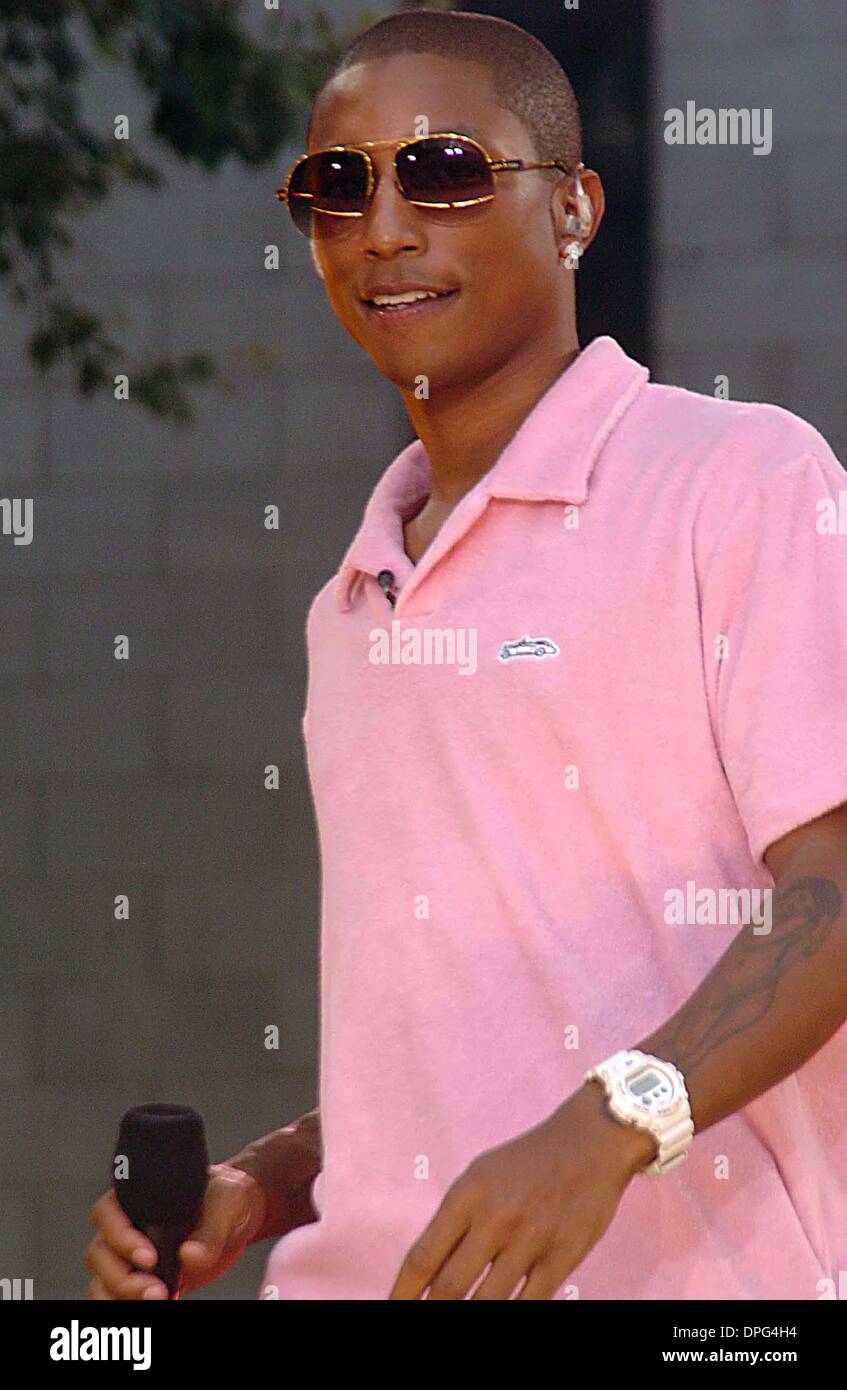 pharrell williams dressed in pink The One Grooming Move Behind Pharrell's Aging-in-Reverse Skin