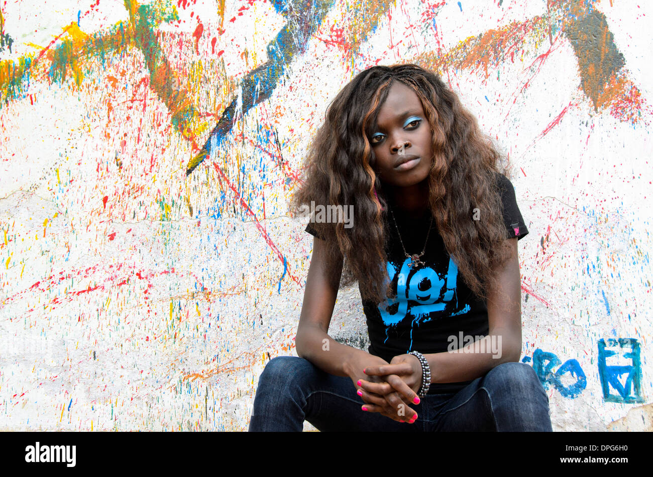 Young African woman sitting Stock Photo - Alamy