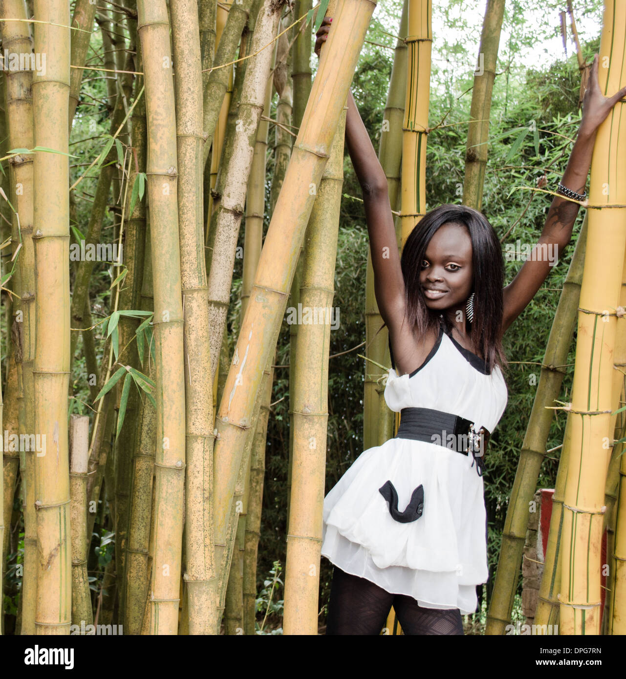 Young African woman stands between bamboo plants Stock Photo - Alamy