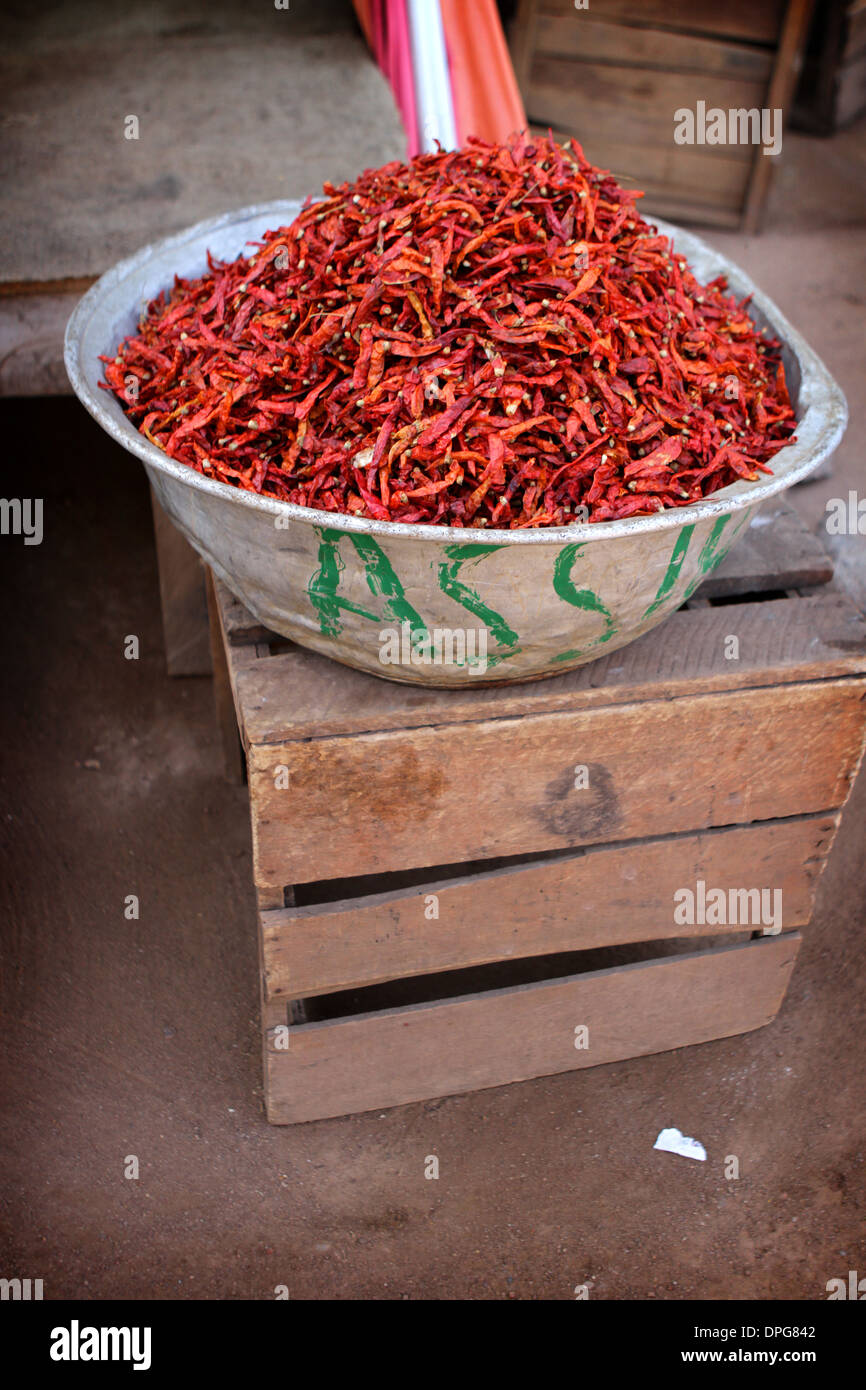 Piles of red chillis for sale in a street market in Ghana, West Africa Stock Photo
