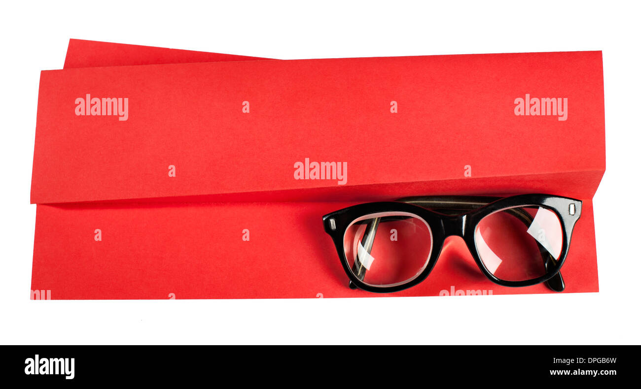 Vintage eyeglasses with black frame on red creative support Stock Photo