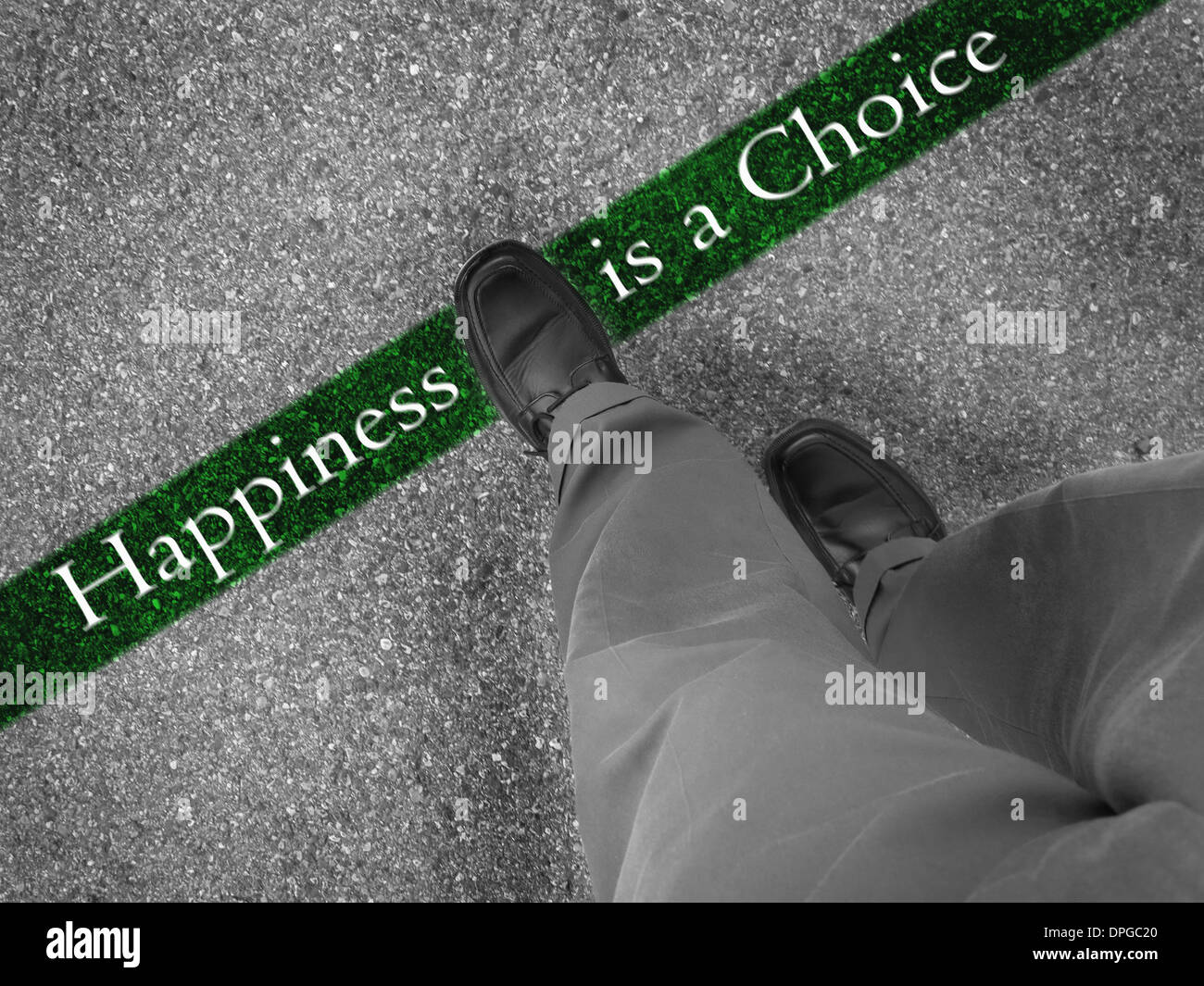 Man walking across a green line with words happiness is a choice Stock Photo