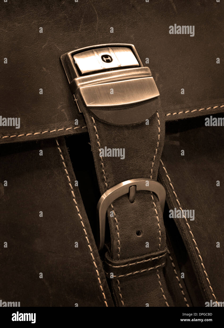 Metal clasp on old leather case with stitching Stock Photo