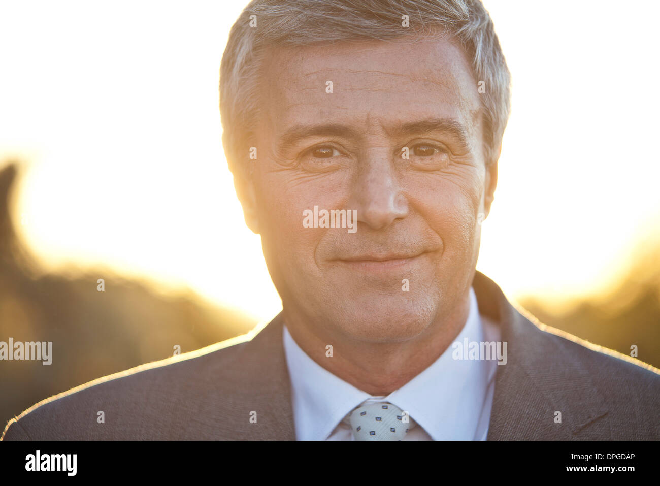 Mature business executive, backlit, portrait Stock Photo