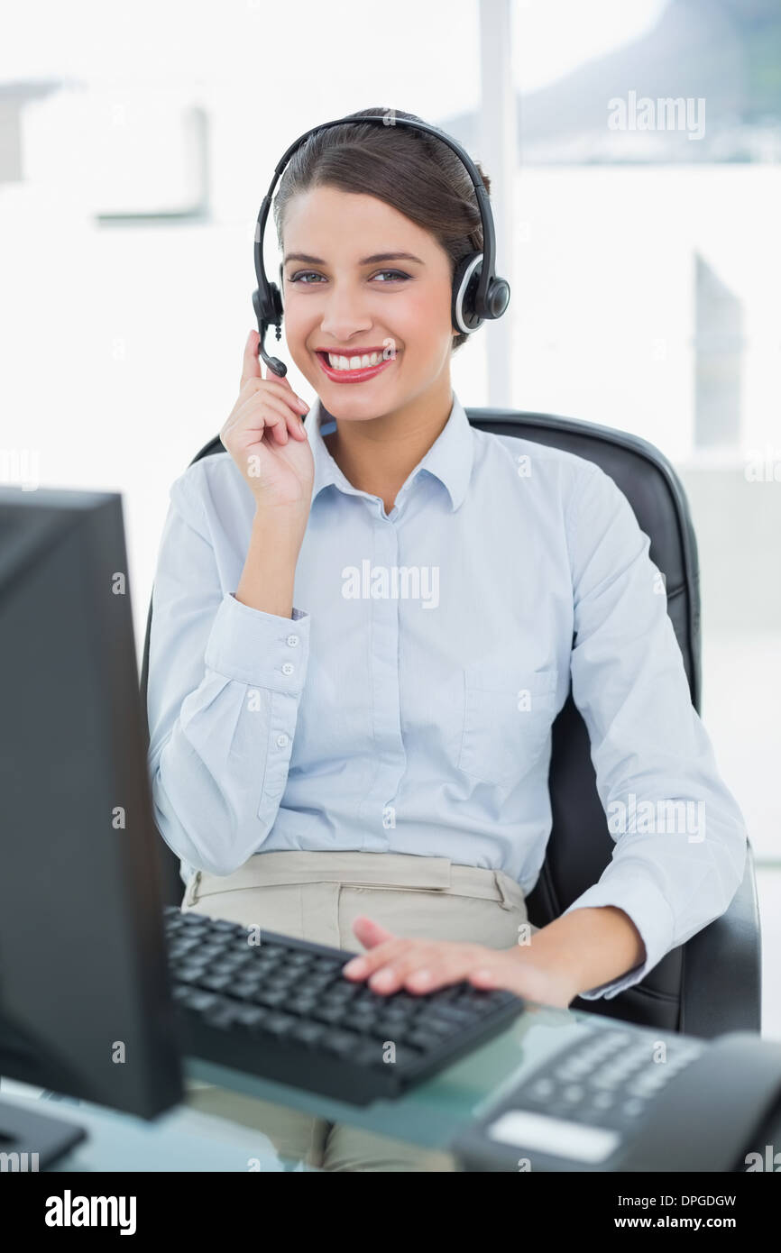 Pretty classy brown haired operator answering a call Stock Photo