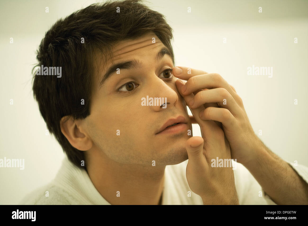 Man putting in contact lens, close-up Stock Photo