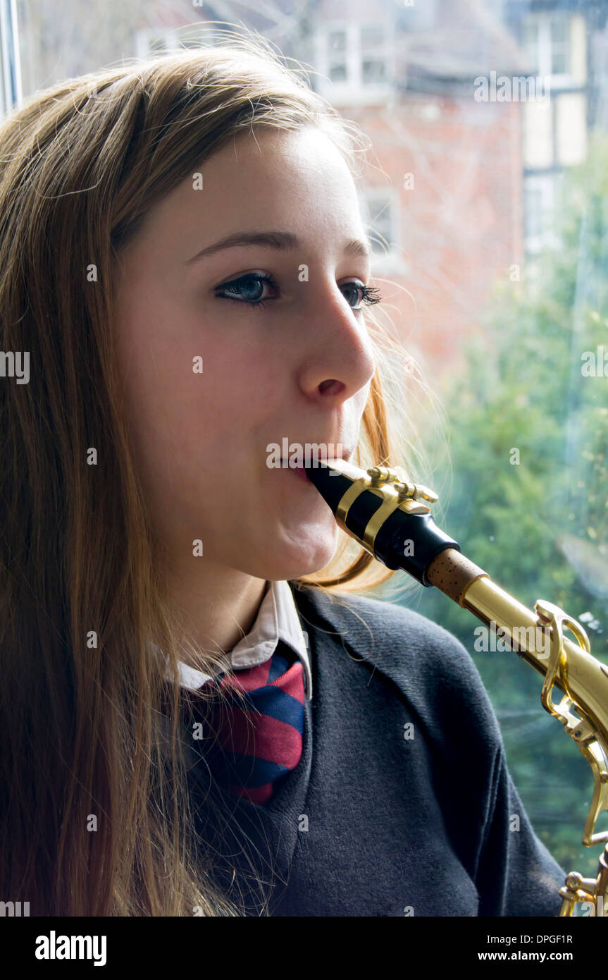 Girl playing saxophone school uniform Stock Photo Alamy