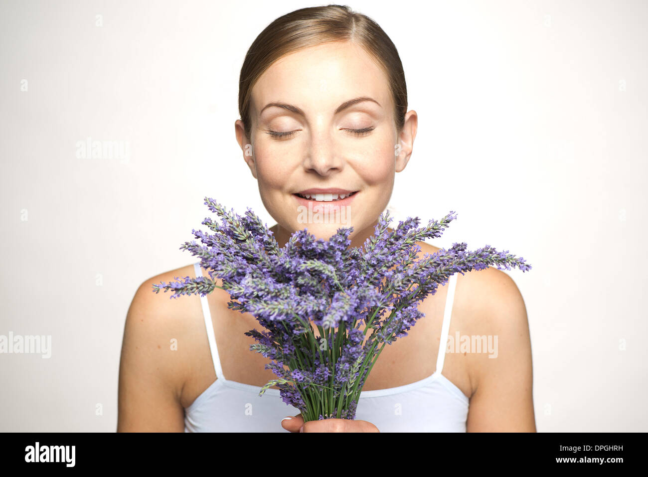 Woman smelling bouquet of fresh lavender with eyes closed Stock Photo ...