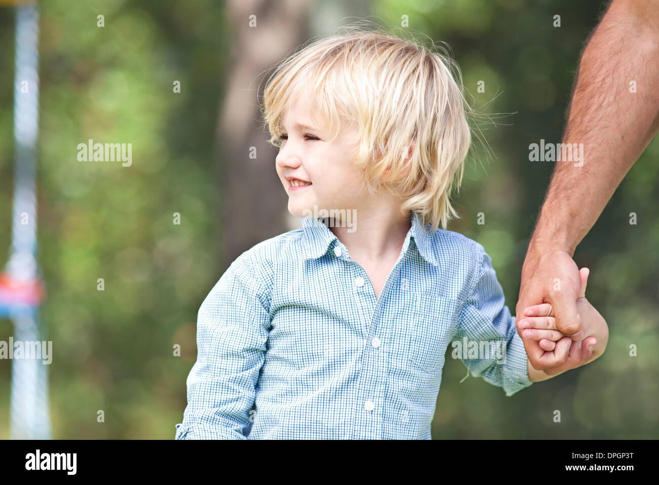 Little boy holding father's hand Stock Photo - Alamy