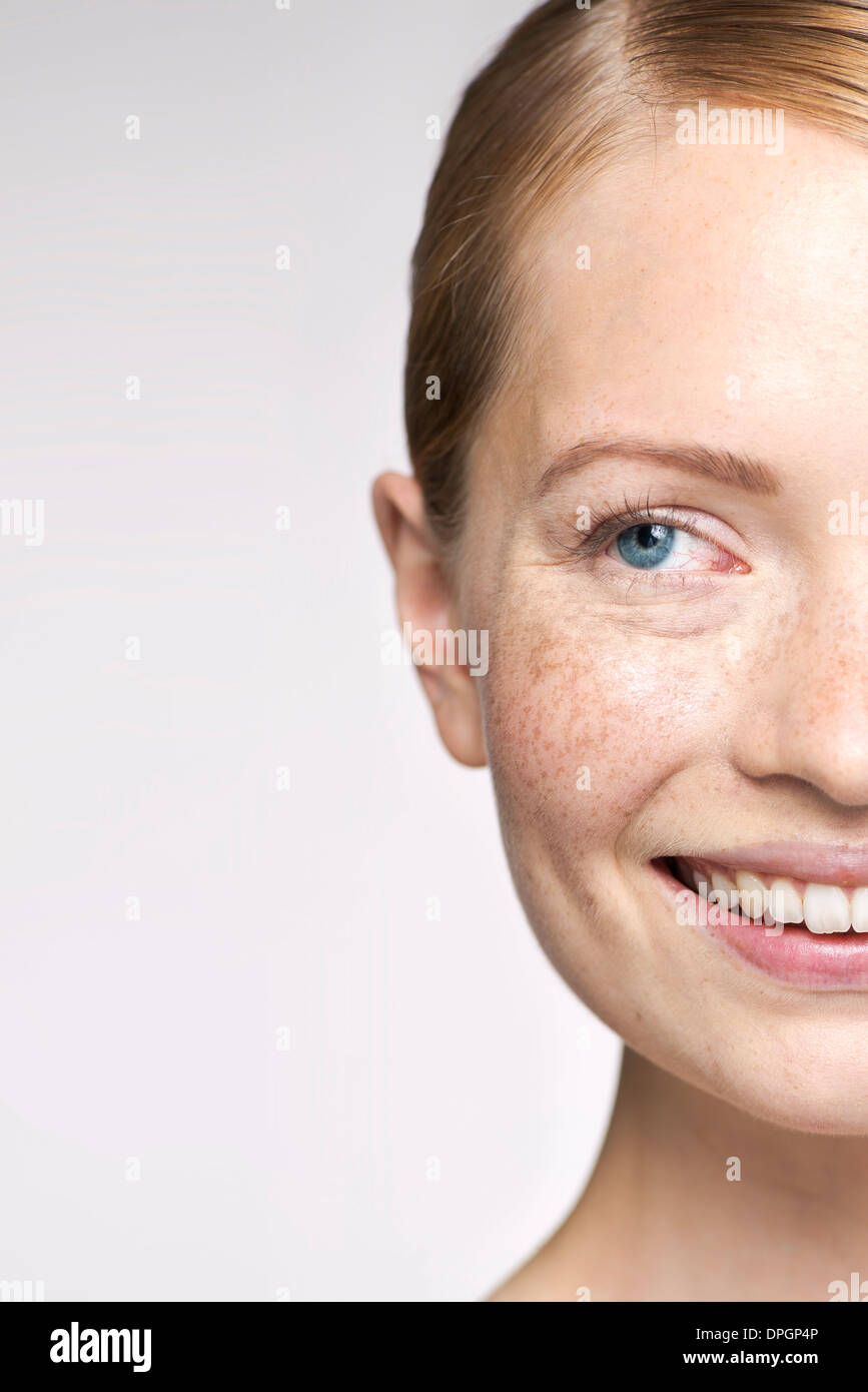 Young woman smiling and looking away thoughtfully, portrait Stock Photo