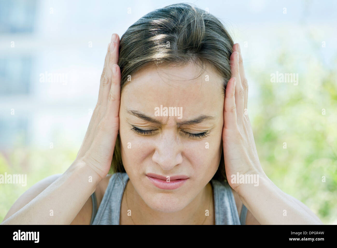 Distressed woman with head in hands Stock Photo