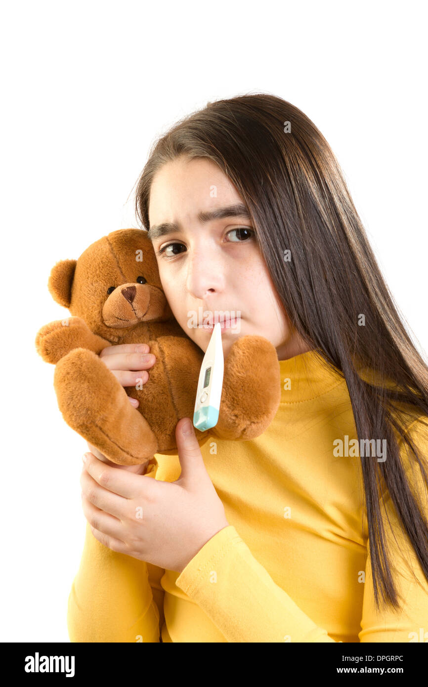 cute sick girl measures the temperature and holding teddy bear Stock Photo