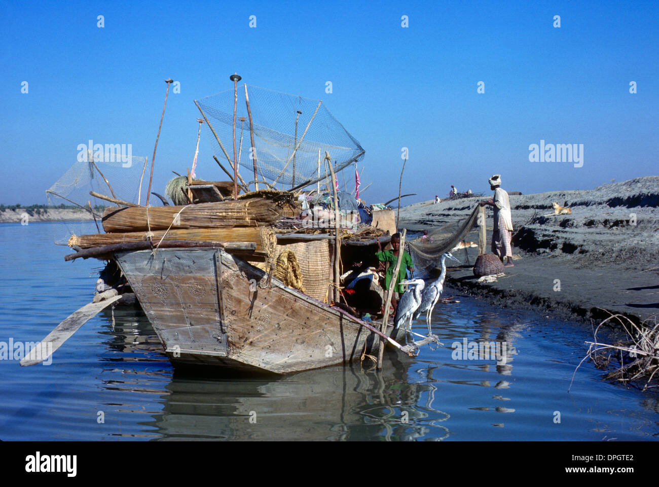 Fisherman and boat Indus River Sind Pakistan Stock Photo