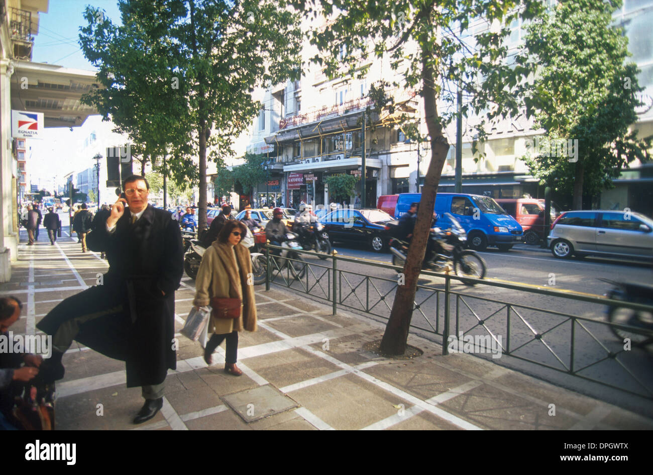 greece athens stadiou street a shoe cleaner cleaning a business mans