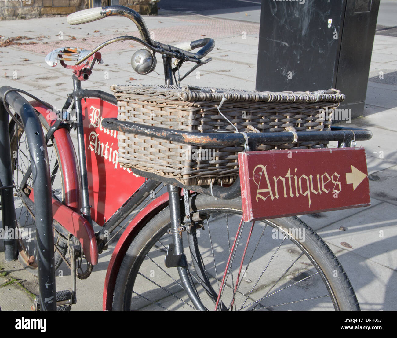 Classic push bike used to promote local antiques shop Stock Photo