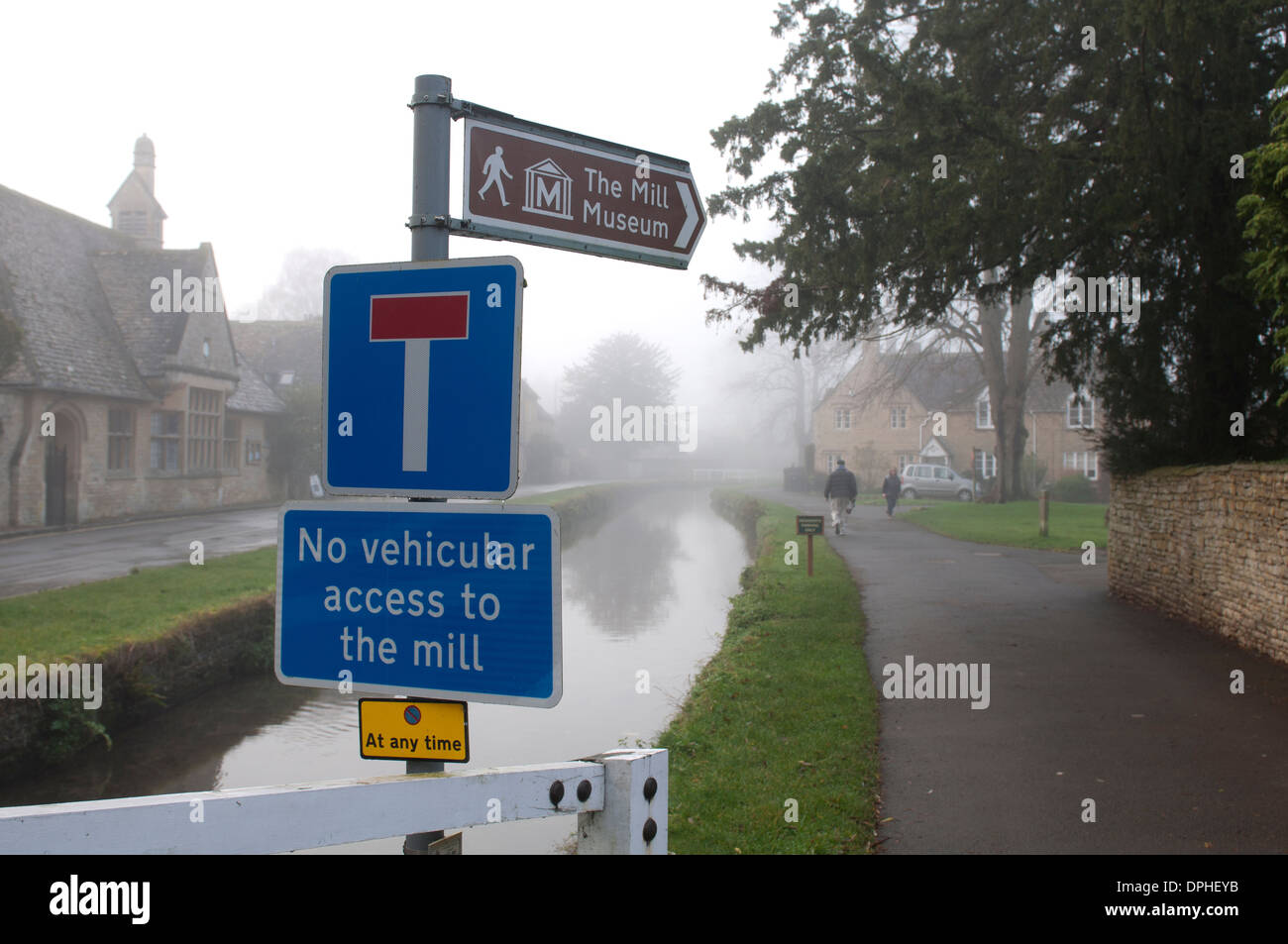 Signs in Lower Slaughter village, foggy weather, Gloucestershire, UK