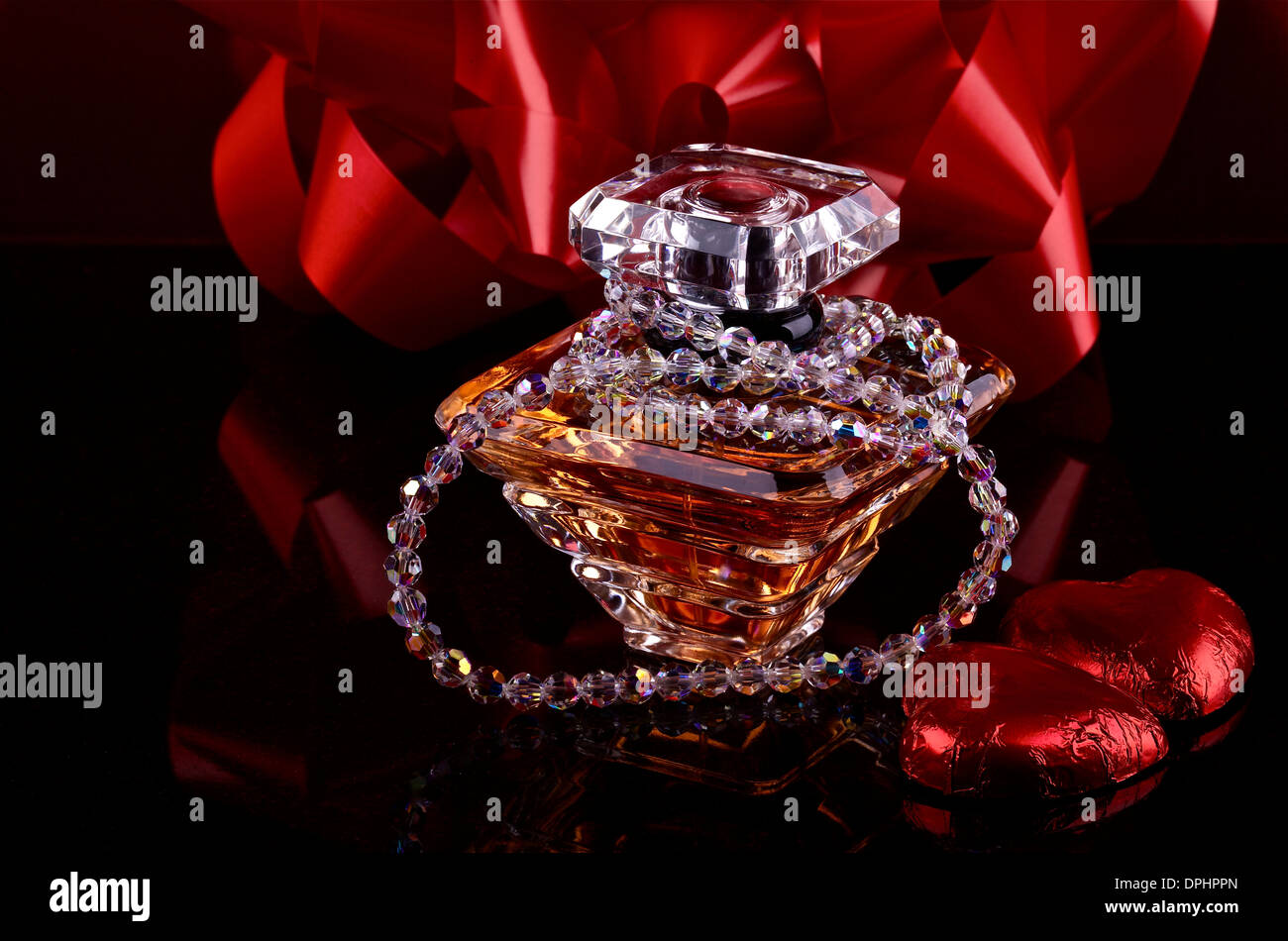 Bottle of perfume on black background with decoration Stock Photo