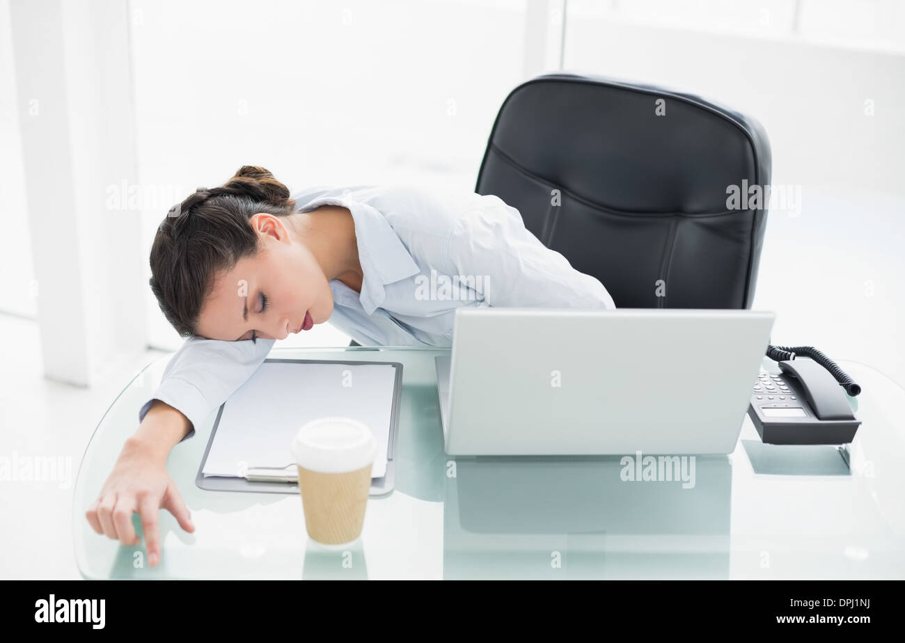 Exhausted stylish brunette businesswoman sleeping on her desk Stock ...