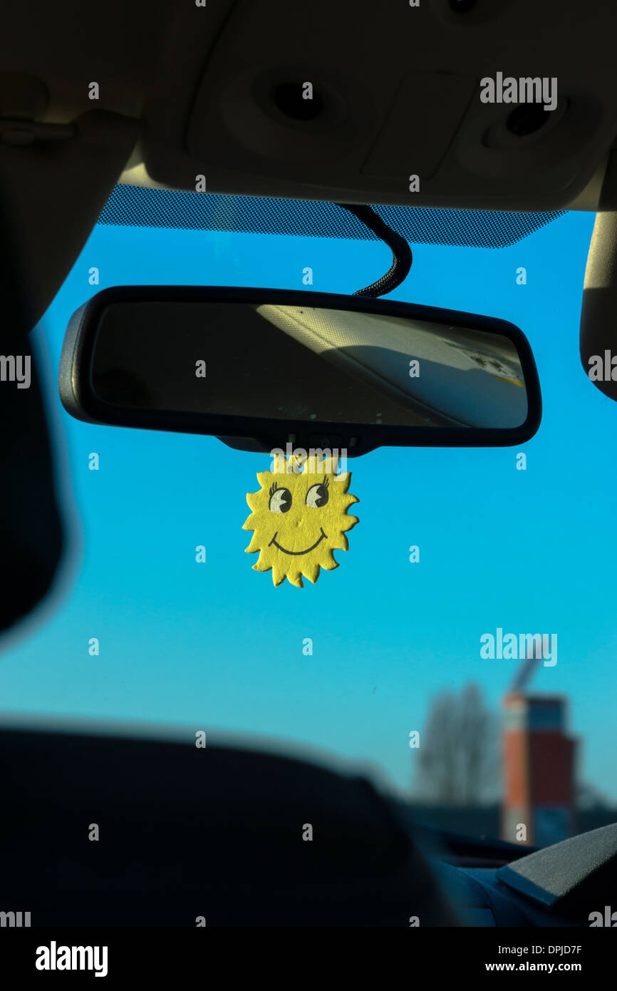 clear day sun yellow smiley face car window blue Stock Photo