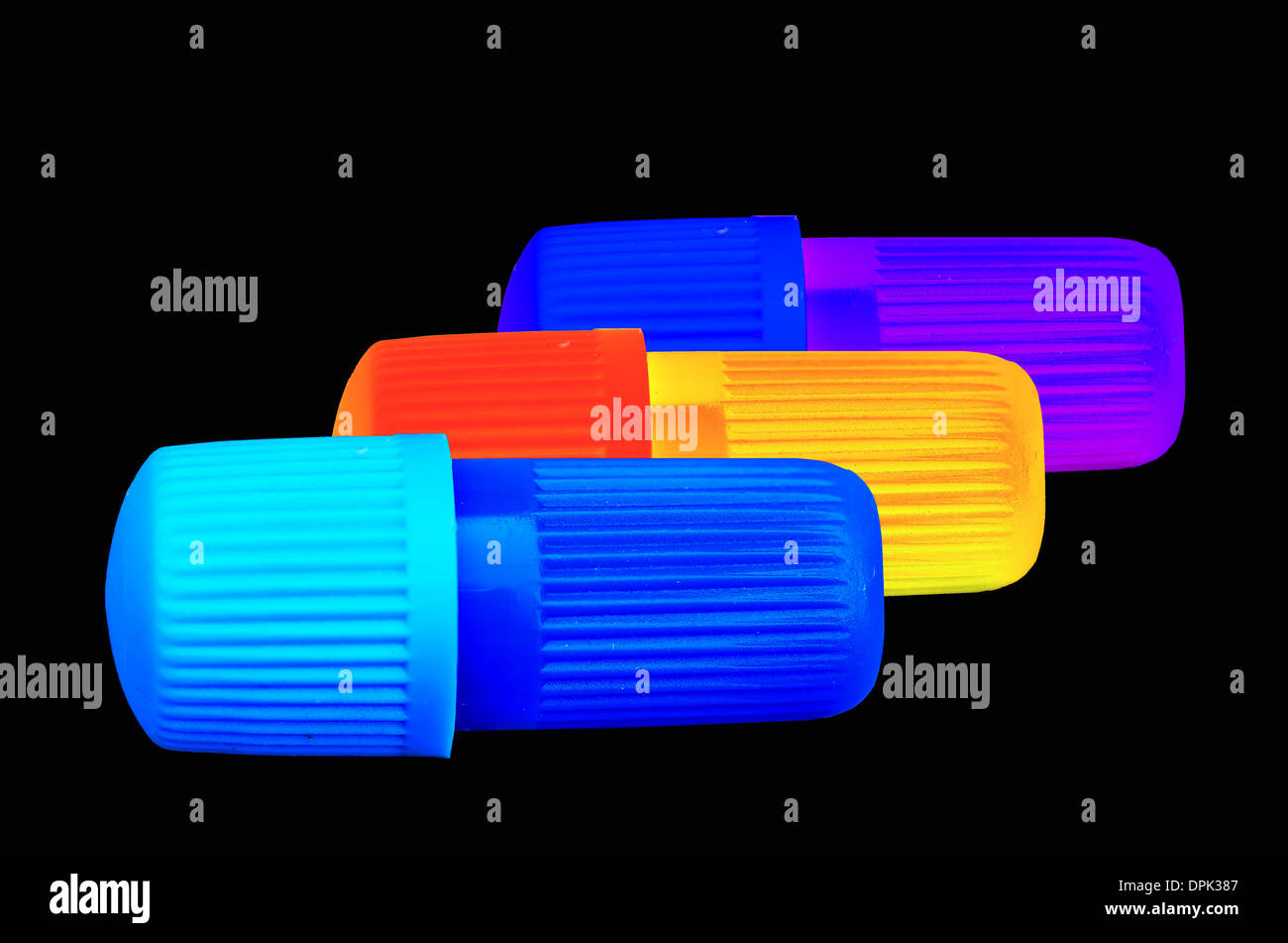 Muticolored small plastic tubes on black background Stock Photo Alamy