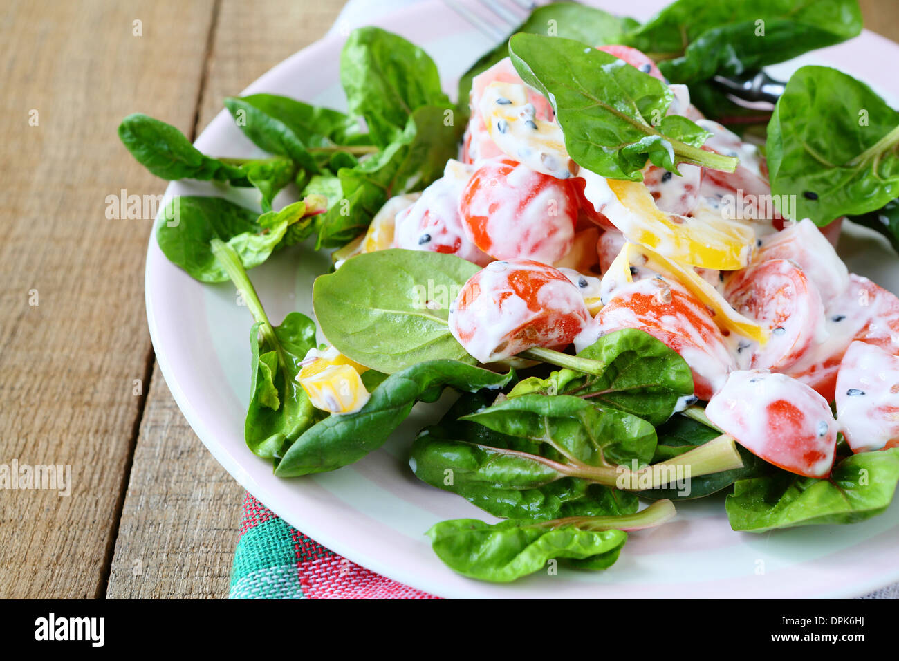 salad of peppers, tomatoes with Greek yogurt, food closeup Stock Photo