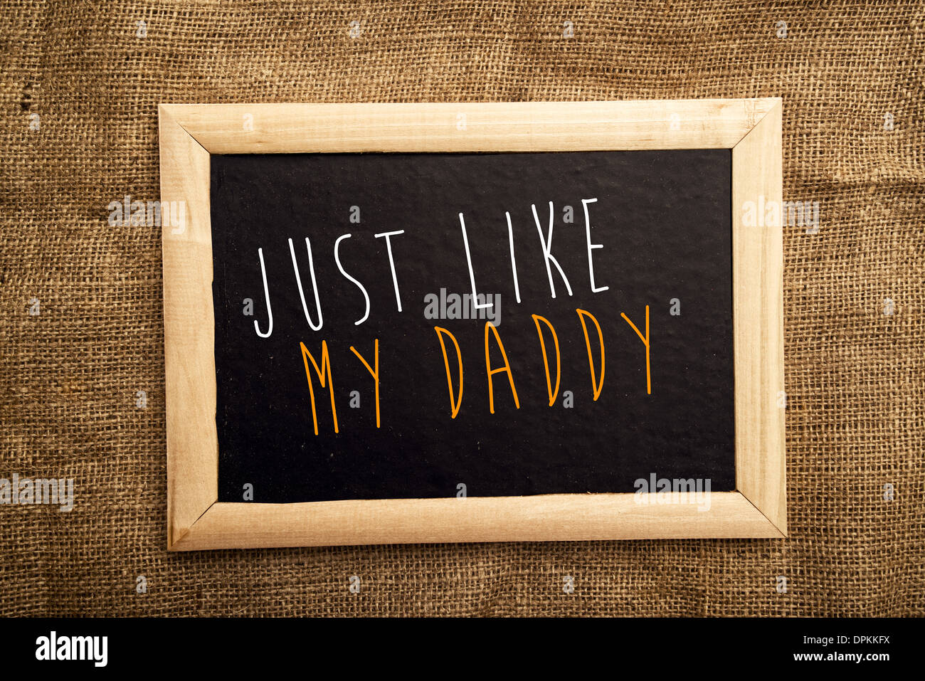 Just like my daddy note on black message board Stock Photo