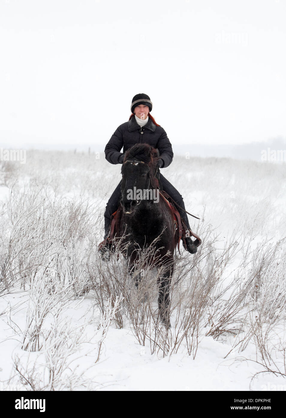 Girl takes a walk on the horse in winter Stock Photo