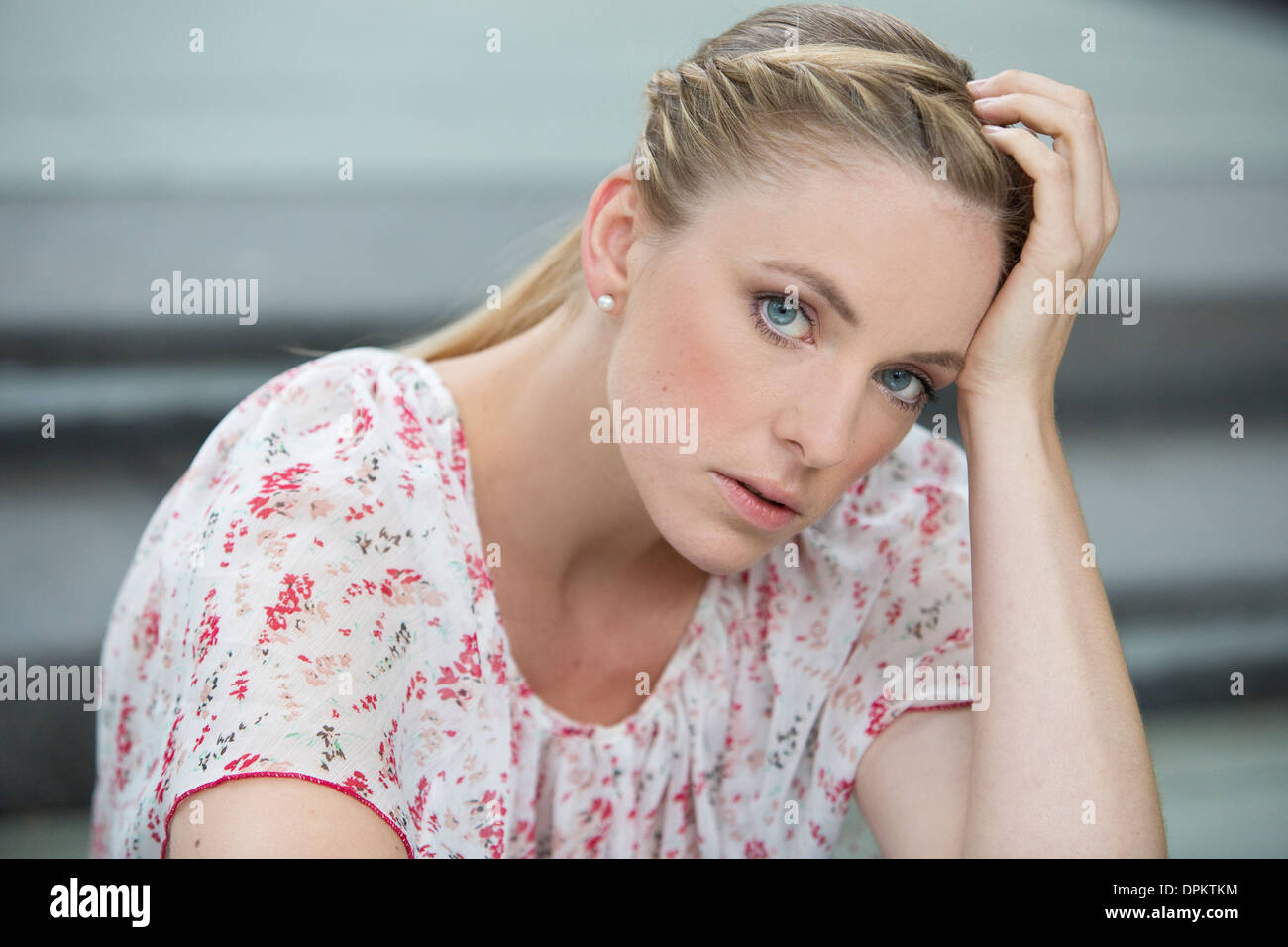 Portrait of young woman sitting on stairs Stock Photo