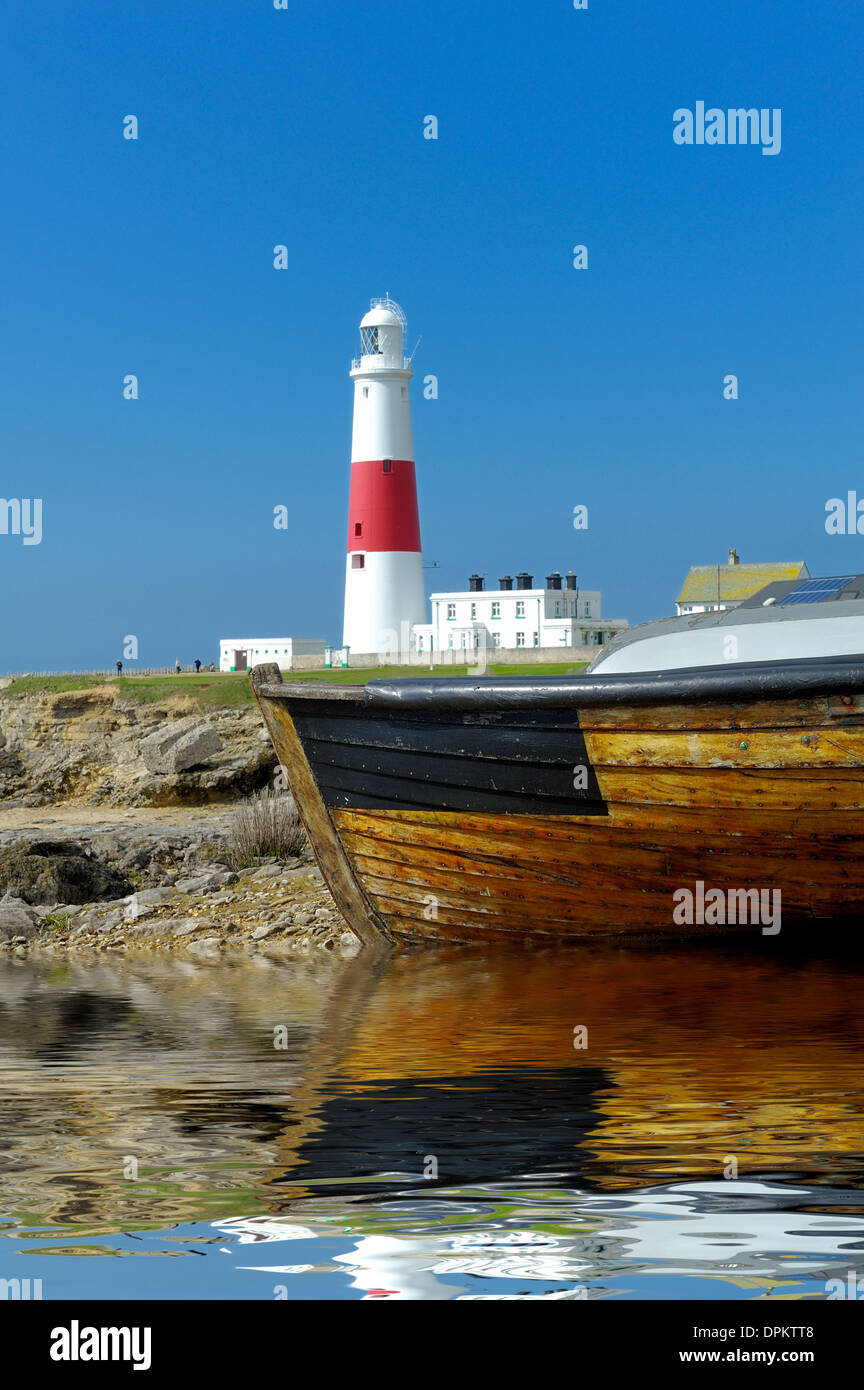 Portland Bill Lighthouse and a rowing boat Reflected into a digitally created pool of water Dorset England uk Stock Photo