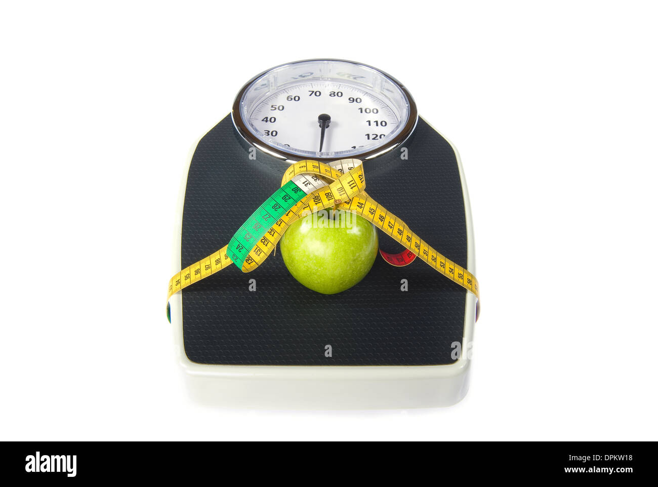 A weight scale with measuring tape and an apple Stock Photo