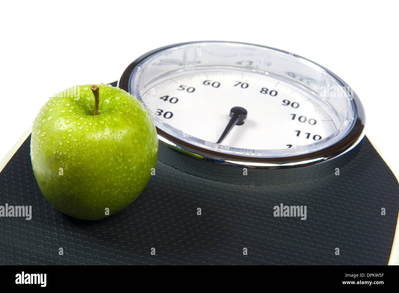 A weight scale with an apple Stock Photo