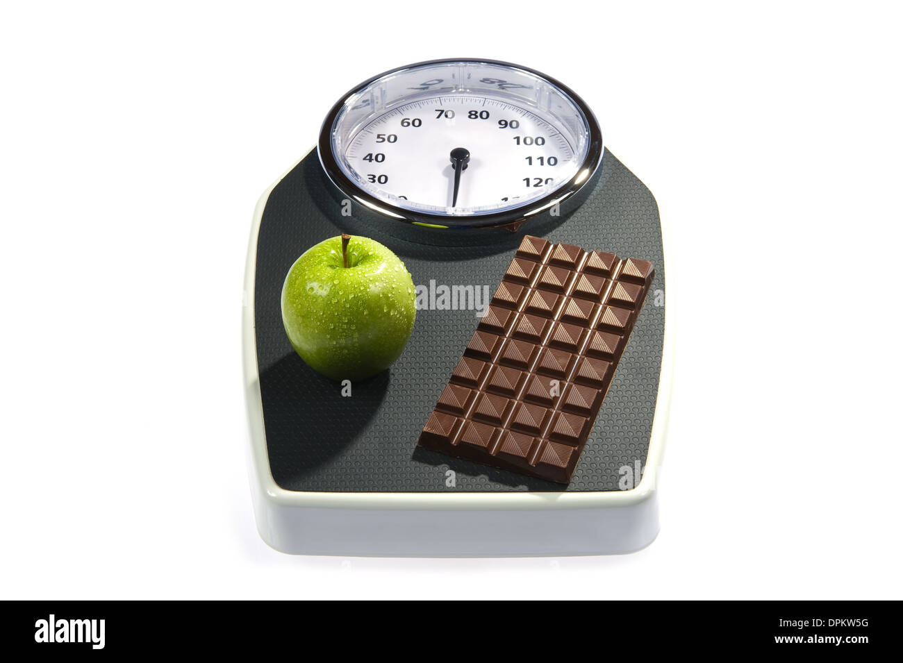 A weight scale with chocolate and an apple Stock Photo
