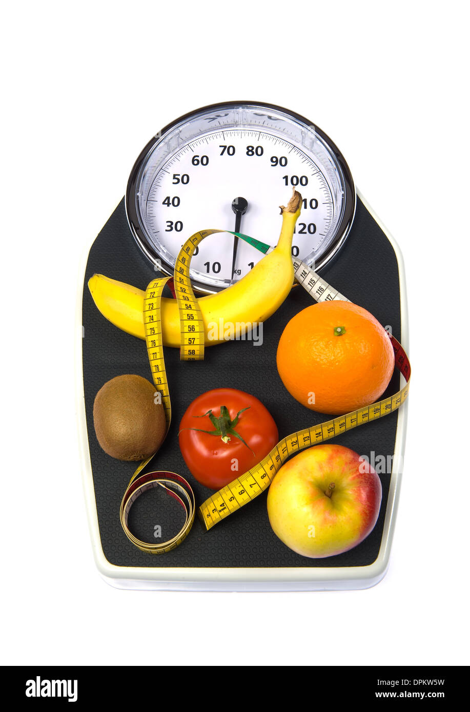 A weight scale with fruit and measuring tape Stock Photo