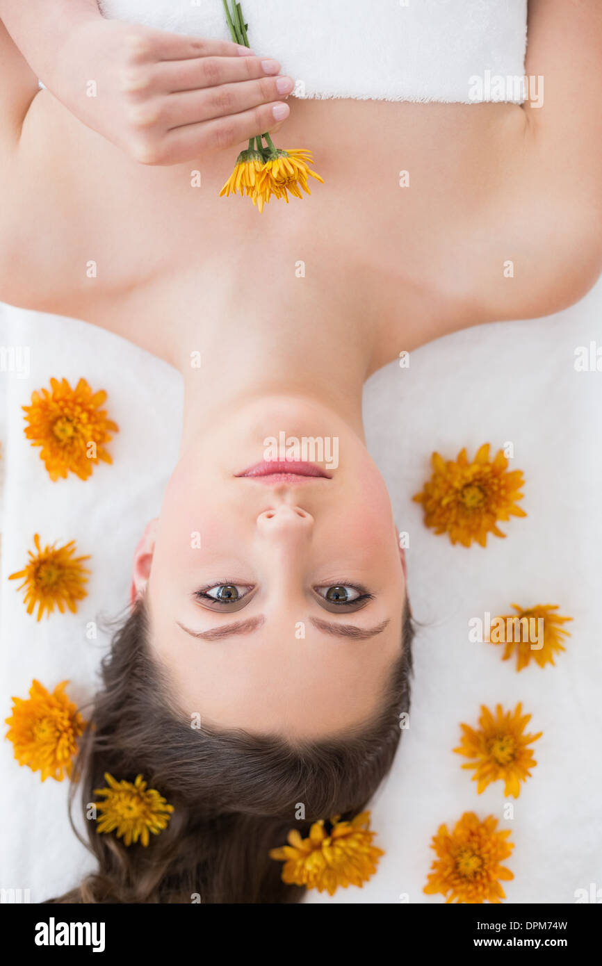 Brunette lying on massage table in beauty salon Stock Photo - Alamy