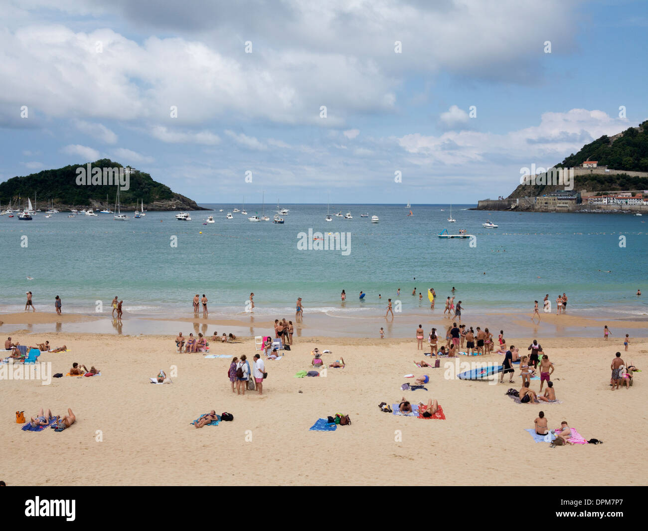 Families, swimmers and sunbathers relaxing on a sunny day on La Concha beach in San Sebastian (Donostia), Basque Country, Spain Stock Photo