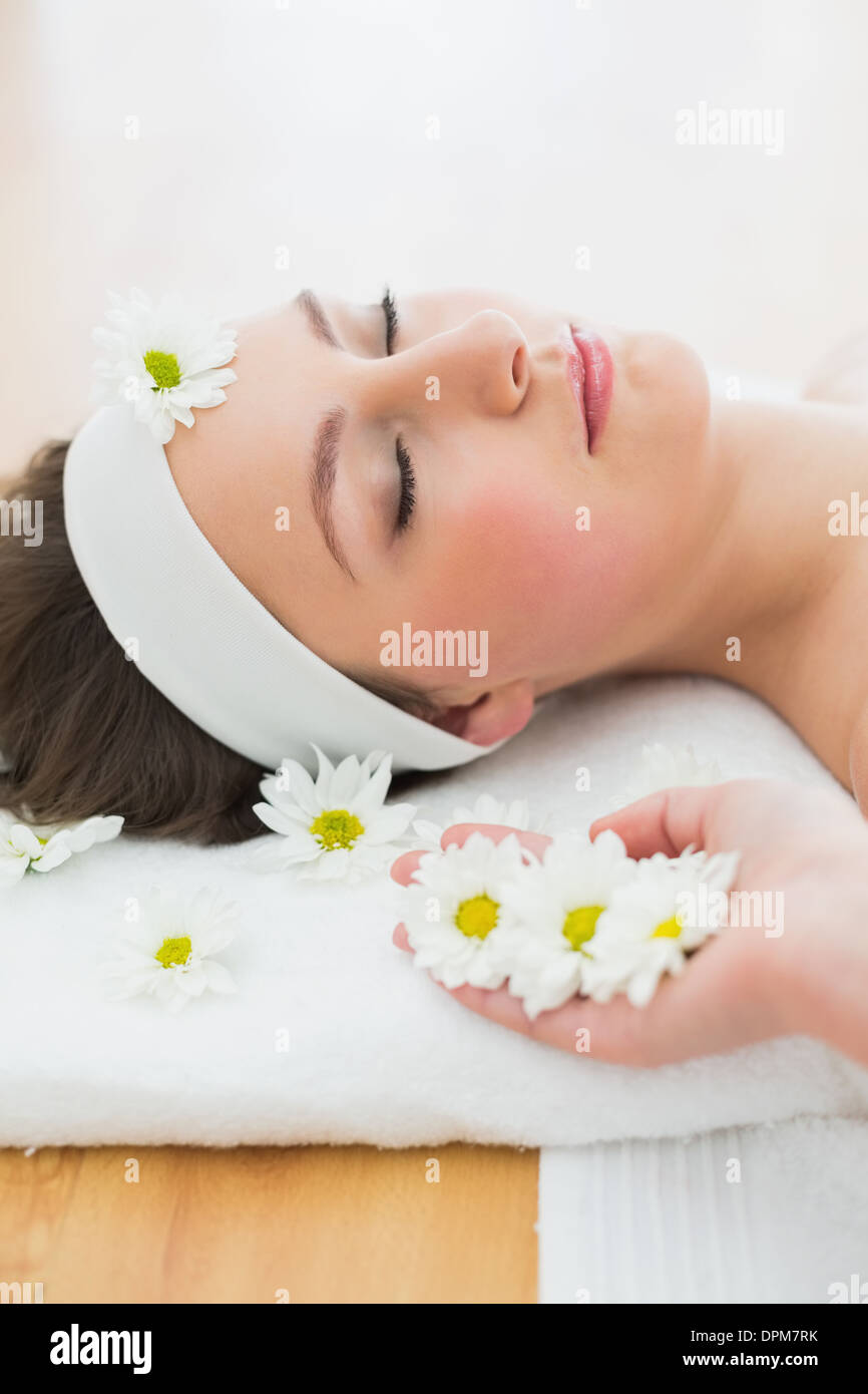 Beautiful woman lying on massage table in beauty salon Stock Photo - Alamy