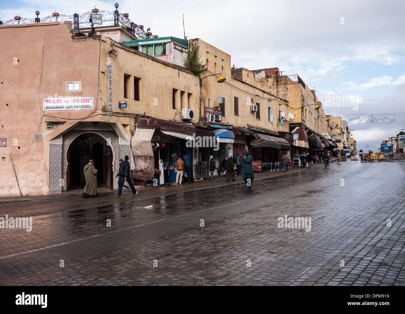 A street in Meknes Morocco showing typical Moroccan buildings and shops Stock Photo