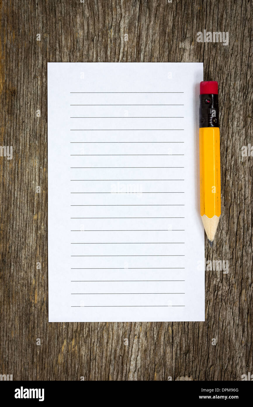 Pencil and lined paper on the wood background Stock Photo - Alamy