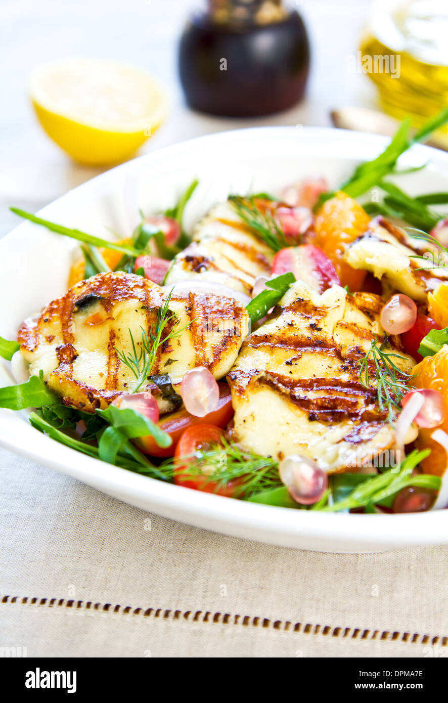 Grilled Halloumi with Pomegranate,Orange and Rocket salad Stock Photo